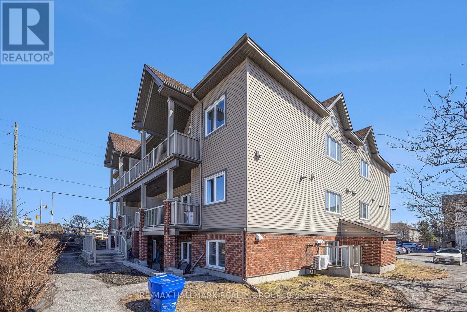 A two-story residential building with a balcony on the second floor.
