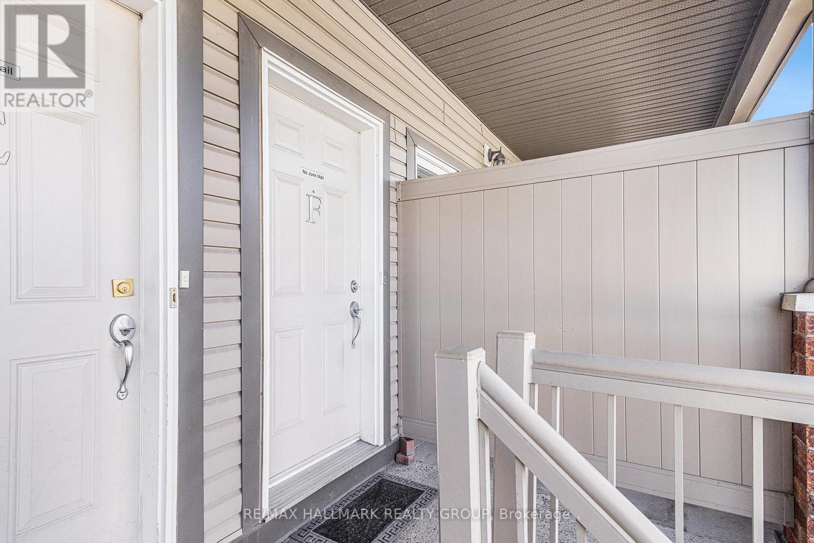 A white door with a gold handle is on the left side of the image.