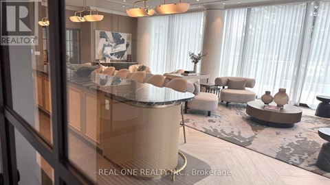 A modern living room with a curved sofa and a coffee table.