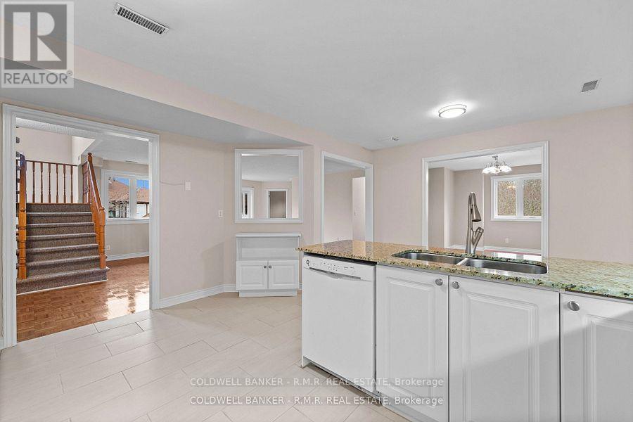 A kitchen with white cabinets and a green countertop is shown.