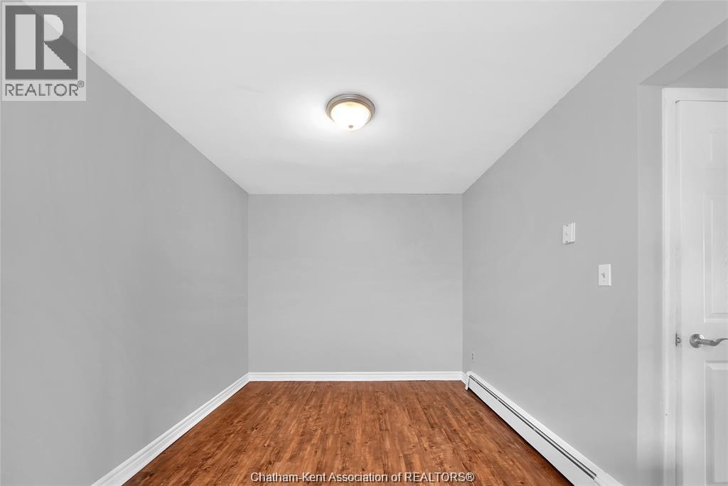 A room with a wooden floor and white walls.