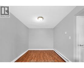 A room with a wooden floor and white walls.