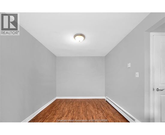 A room with a wooden floor and white walls.