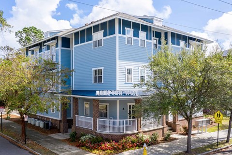 A blue building with a white fence and a sign that says "NANK".