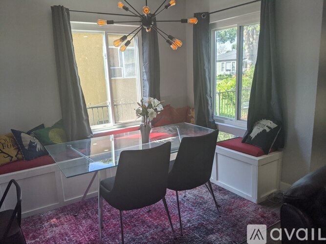 A dining room with a glass table and chairs.