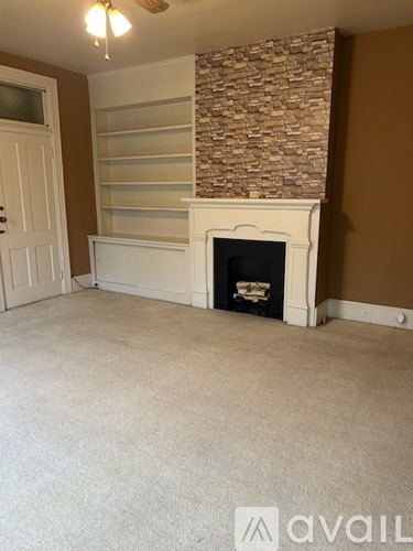 A room with a fireplace and a door.