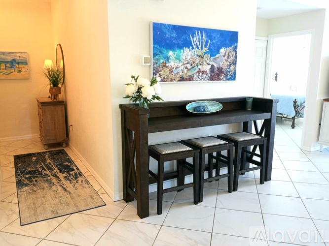 A dining room with a table and chairs.