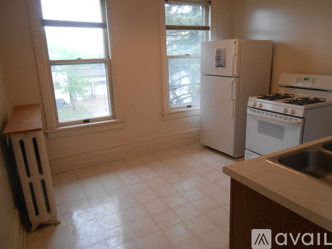 A kitchen with a white fridge and stove.