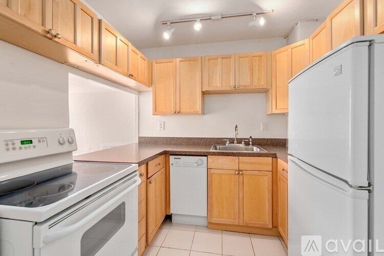 A kitchen with wooden cabinets and white appliances.