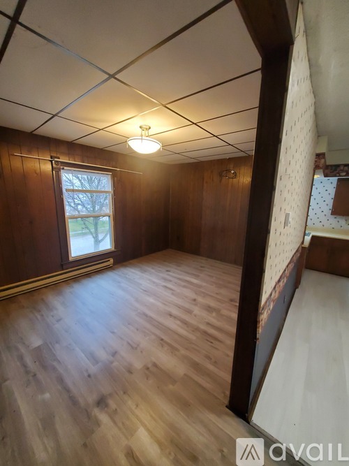A room with wooden floors and a window.