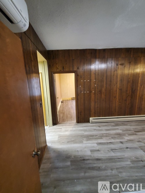 A room with wooden walls and a tiled floor.
