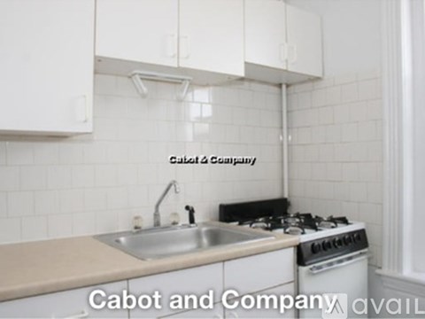 A kitchen with a stove and sink.