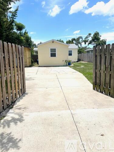 A small house with a fence in front of it.