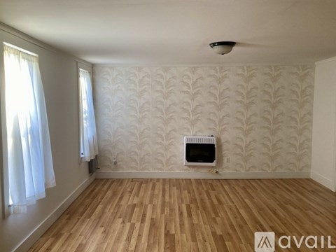 A room with a fireplace and a fan.