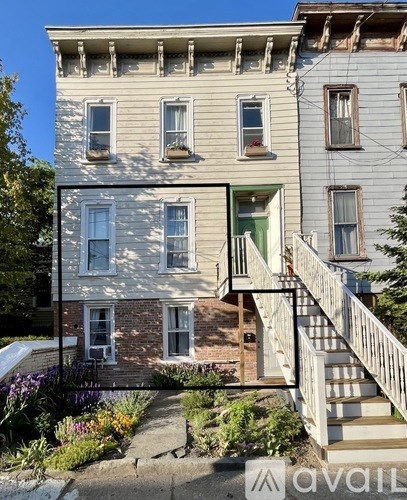 A building with a balcony and a staircase leading to it.