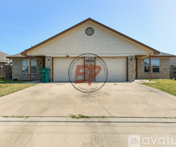 A house with a garage door that has a red cross over it.