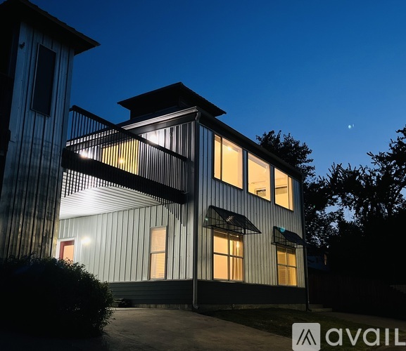 A modern house with a lit up sign that says "available".