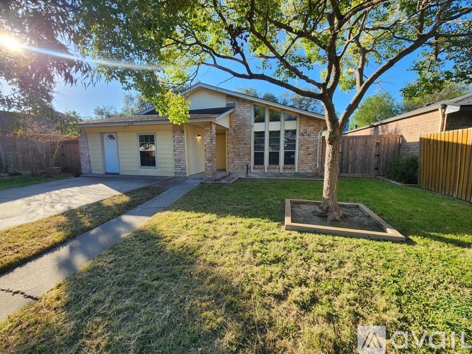 A house with a tree in front of it.