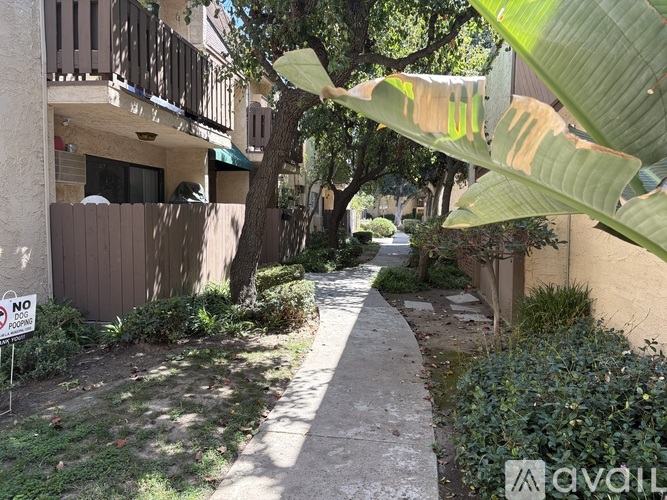 A narrow pathway between two buildings with a "NO" sign on the left.