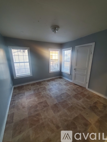 A room with a tiled floor and a window.