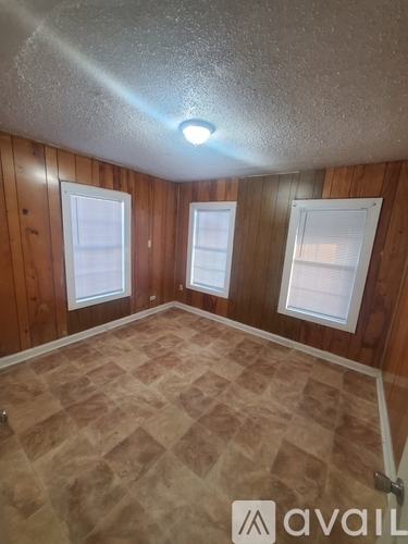 A room with wooden walls and a tiled floor.