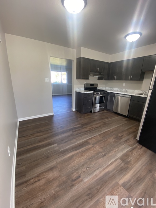 A kitchen with a stove top oven and a dishwasher.