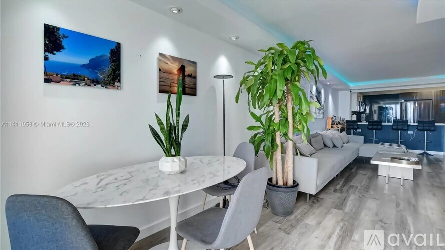 A modern living room with a dining table and chairs.