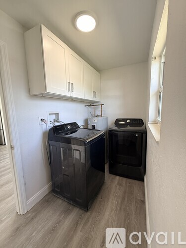 A small kitchen with a black dishwasher and a black oven.