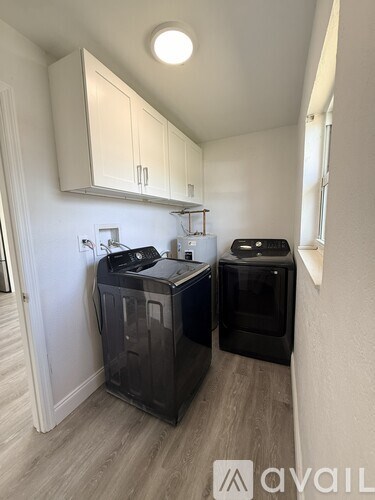 A small kitchen with a black dishwasher and a black oven.