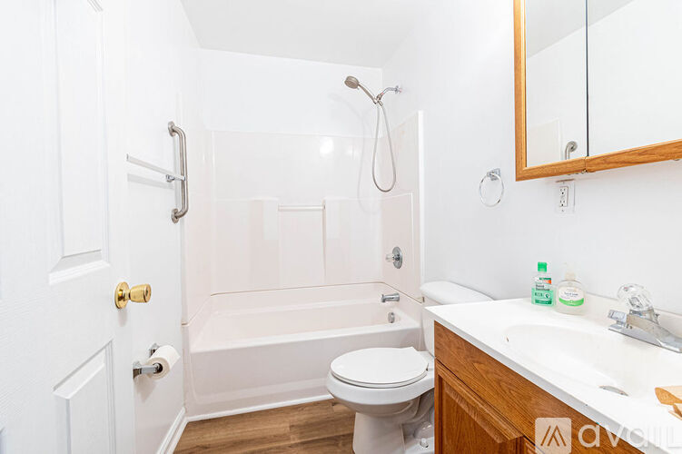 A white bathroom with a toilet, sink, and bathtub.