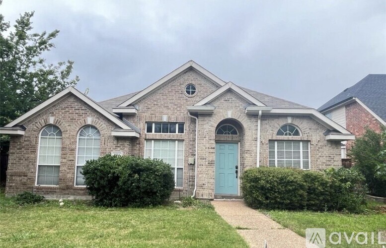 A house with a blue door and windows is for sale.