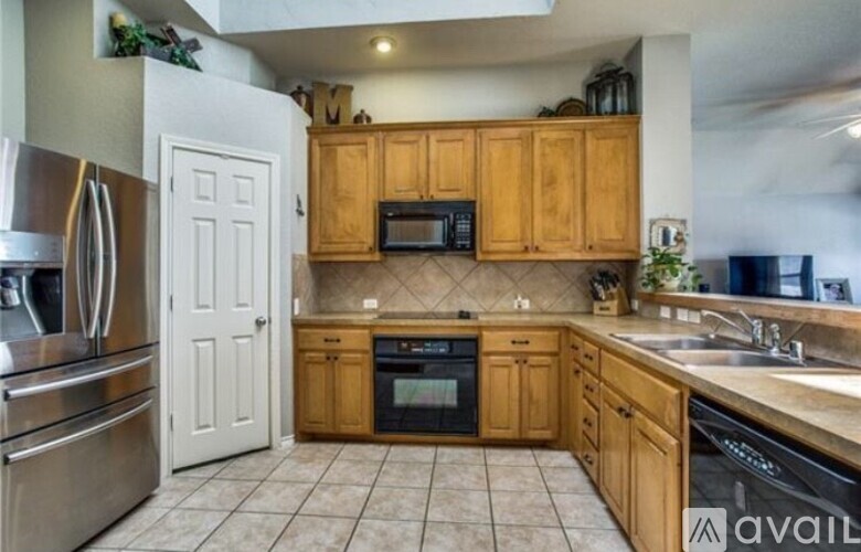 A kitchen with wooden cabinets and a white door.