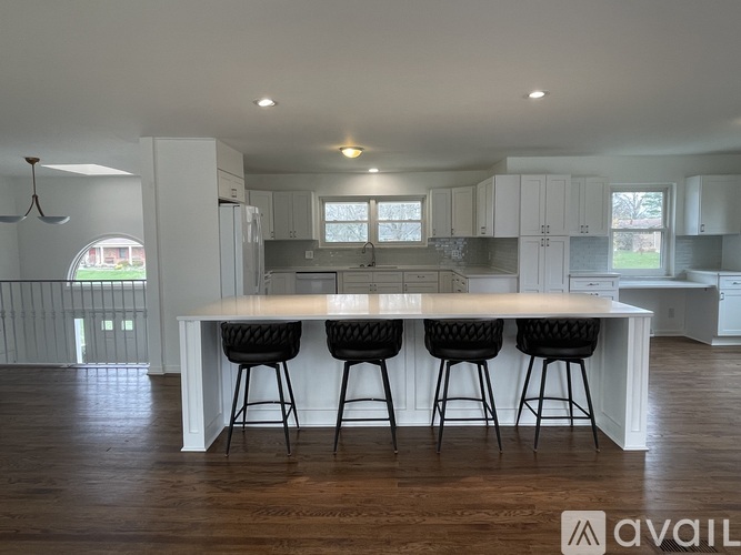 A modern kitchen with white cabinets and a large island.
