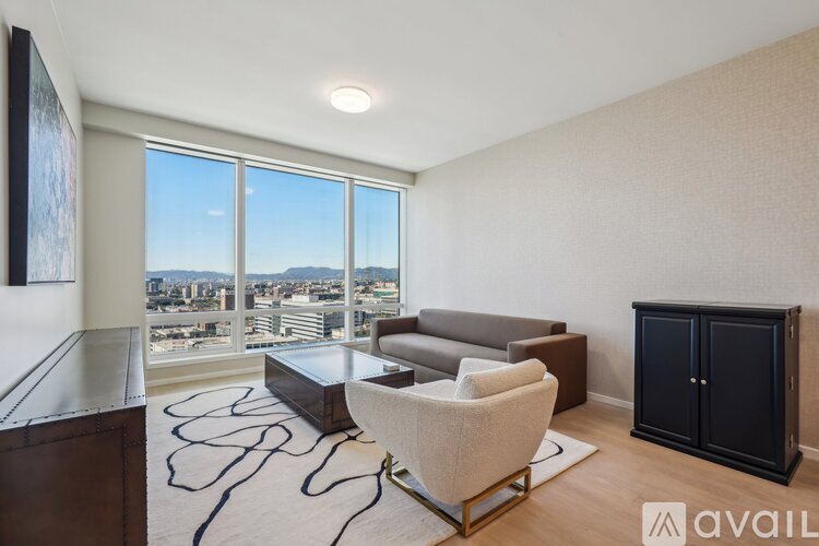 A living room with a large window overlooking a cityscape.