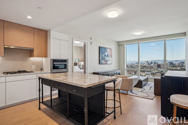 A kitchen with a large island and a view of the city.