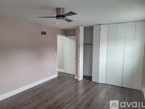 A room with a staircase and a light brown wall.