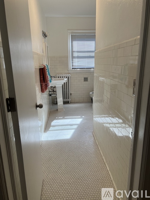 A bathroom with a white tub, toilet, and sink.