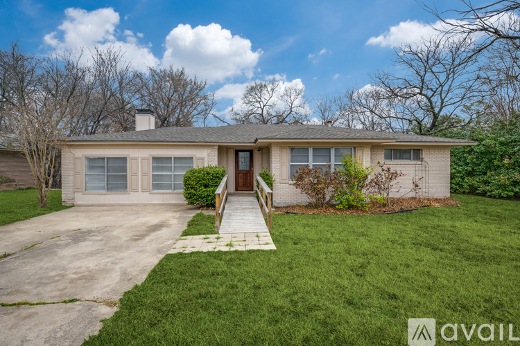 A house with a brown roof and a white wall is available for rent.