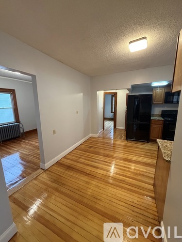 A room with wooden floors and white walls.