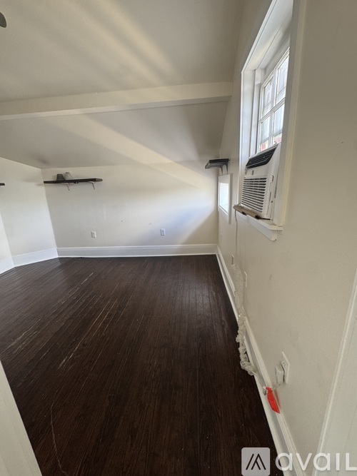 A room with wooden floors and white walls.