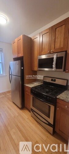 A kitchen with wooden cabinets and stainless steel appliances.