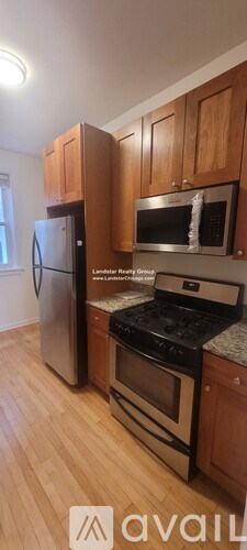 A kitchen with wooden cabinets and stainless steel appliances.