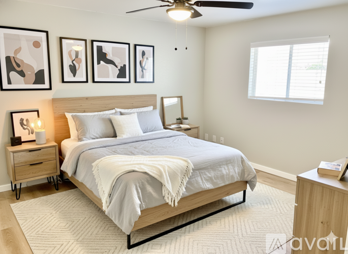 A bedroom with a large bed and a ceiling fan.