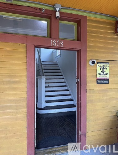 A wooden building with a red door and a sign that says "French Quarter".