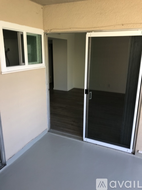 A room with a white door and a window.