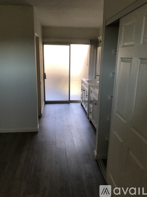 A hallway with a door leading to a bedroom.