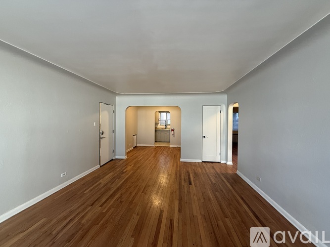 A room with wooden floors and white walls.