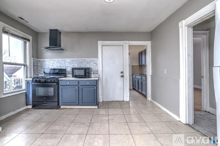 A kitchen with a stove top oven and a microwave.