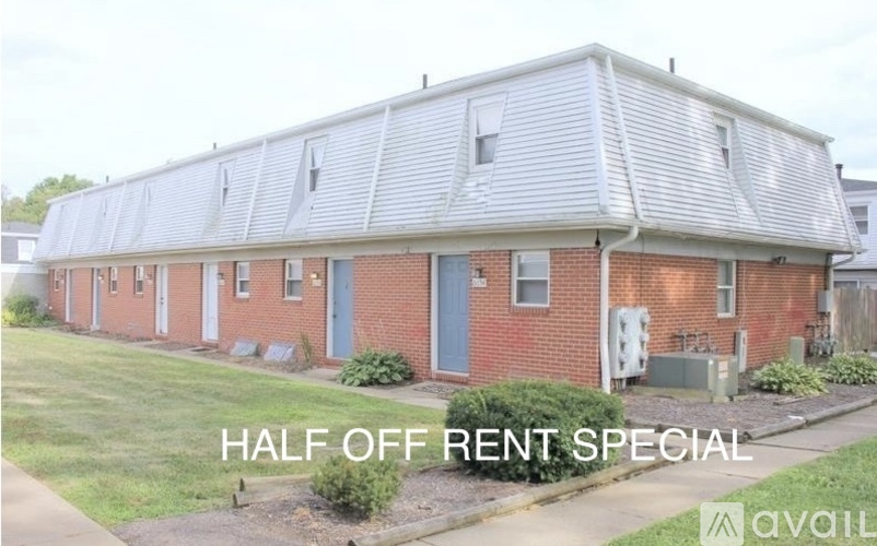 A brick building with the words "Half Off Rent Special" written on it.