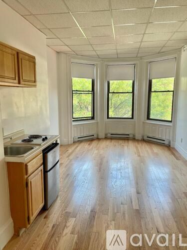 A kitchen with wooden cabinets and a stove top oven.